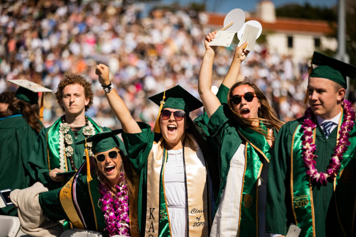 A group of graduating seniors cheering during the Cal Poly Commencement celebration
